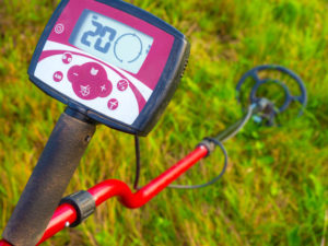 red metal detector on grass